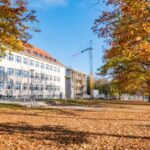 Nanotechnology - white building and yellow trees