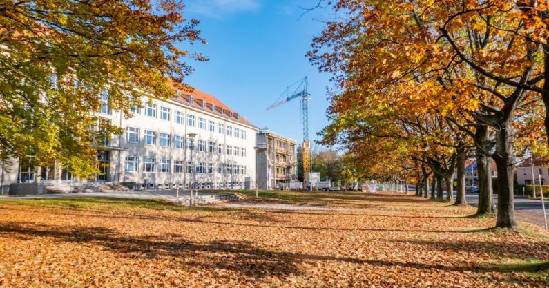 Nanotechnology - white building and yellow trees