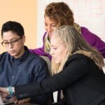 Engineering - Closeup Photo of Three Person Looking at Macbook Air