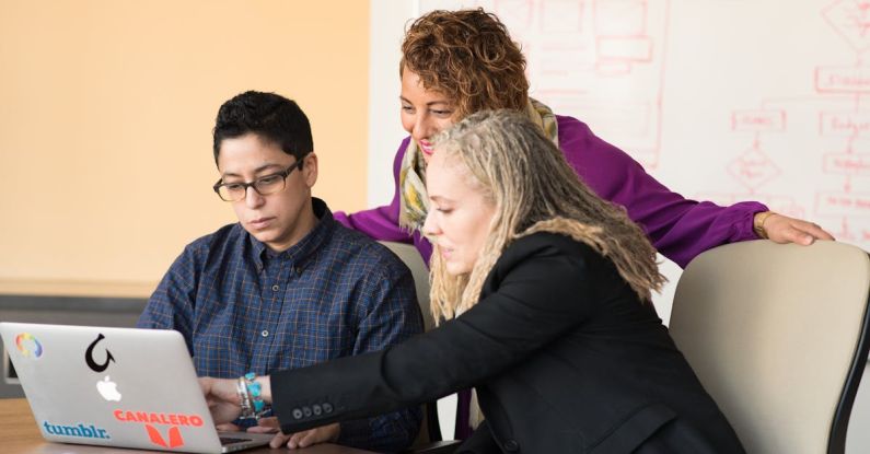 Engineering - Closeup Photo of Three Person Looking at Macbook Air