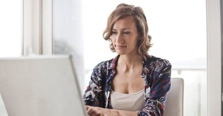 Engineering - Woman in Blue Floral Top Sitting While Using Laptop