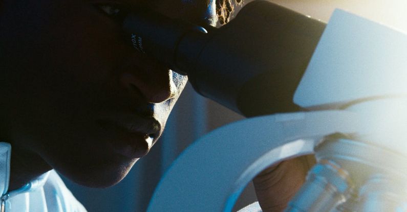 Microscopy - A Man Looking Through the Microscope