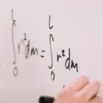 Quantum Physics - Person Writing On White Board