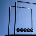 Quantum Physics - Newton s cradle on a table seen from low angle view