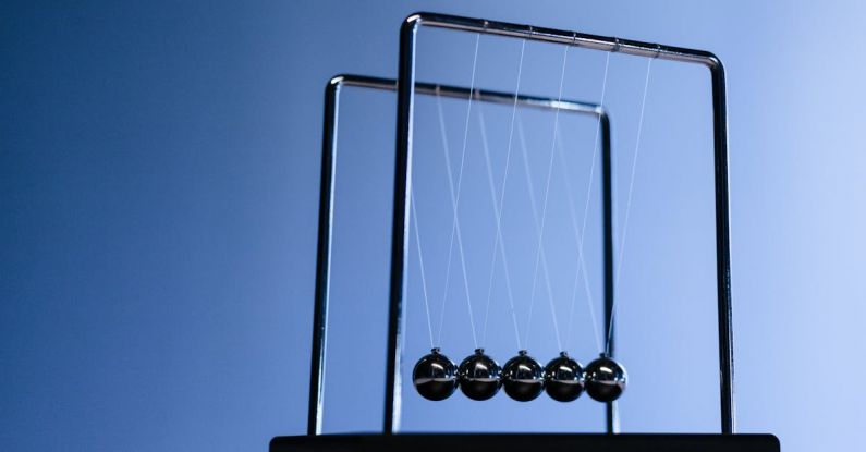 Quantum Physics - Newton s cradle on a table seen from low angle view