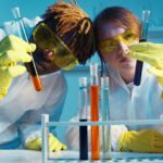 Microscopy - A Man and a Woman Holding a Test Tube