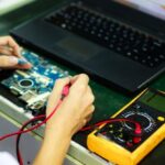 Electronics - Man Soldering a Circuit Board