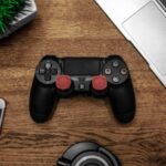 Electronics - Black Game Console on Wooden Surface